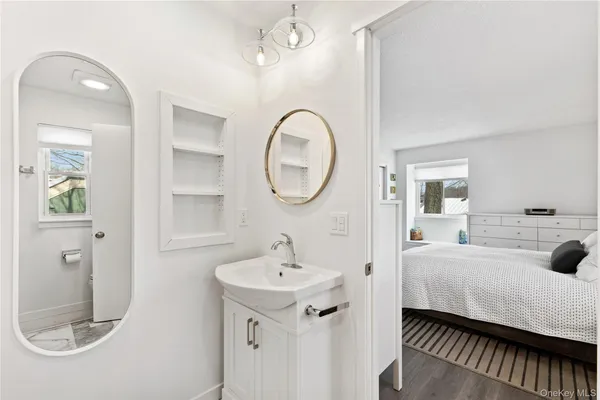 a spacious bathroom with a sink and a mirror