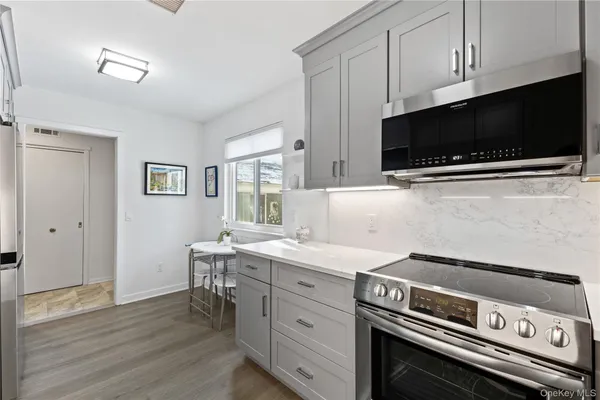 a kitchen with a stove and a microwave