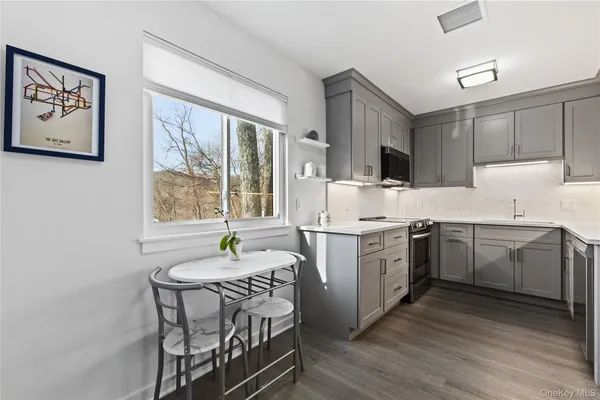 a kitchen with a table chairs sink and cabinets
