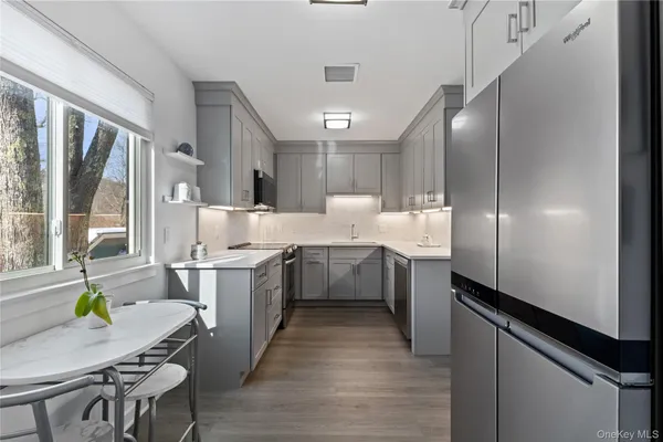 a large kitchen with kitchen island a large island in the center