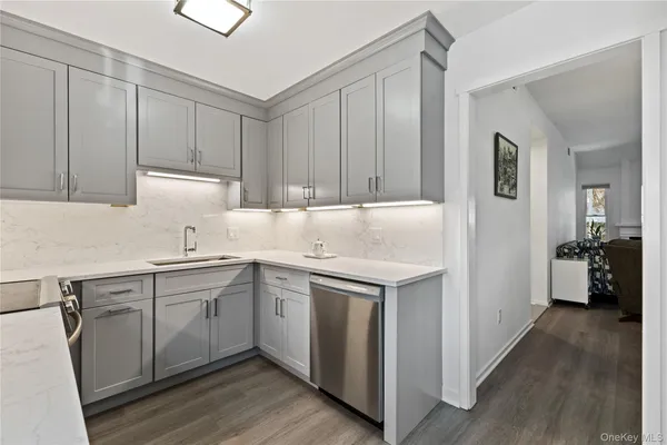 a kitchen with a sink cabinets and wooden floor
