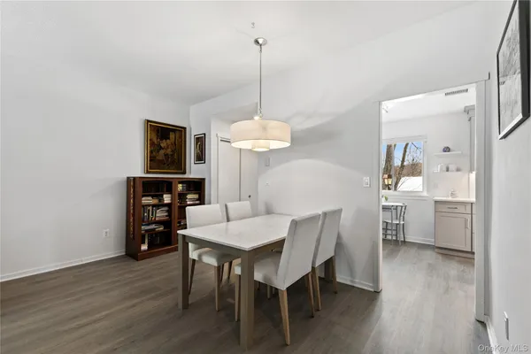 a dining room with furniture and wooden floor