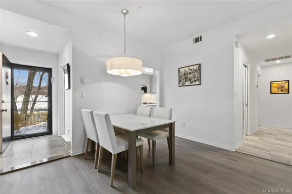 a view of a dining room with furniture window and wooden floor