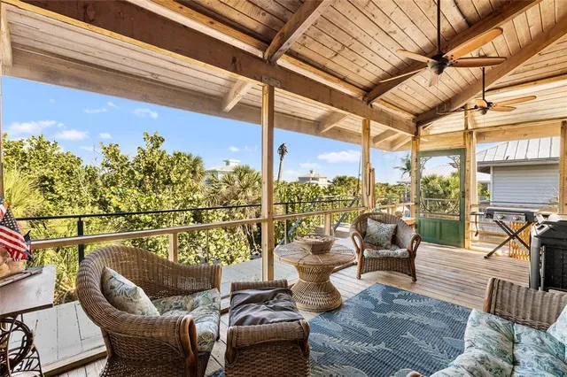 a view of a dining room with furniture a chandelier and wooden floor
