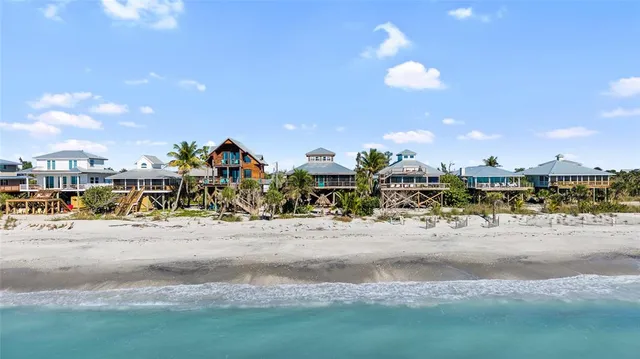 an aerial view of a house with yard and seating space