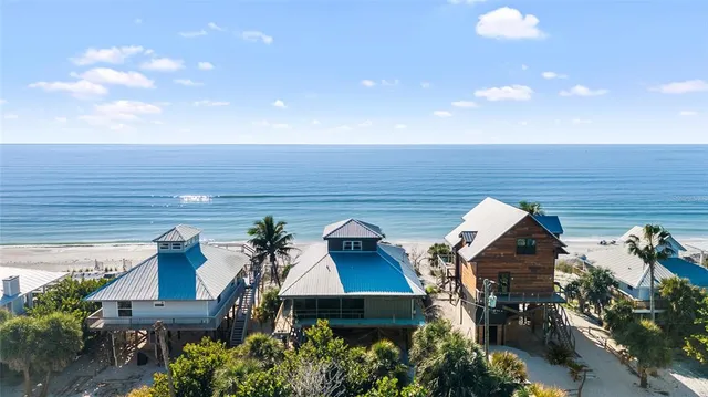 an aerial view of multiple houses with a yard