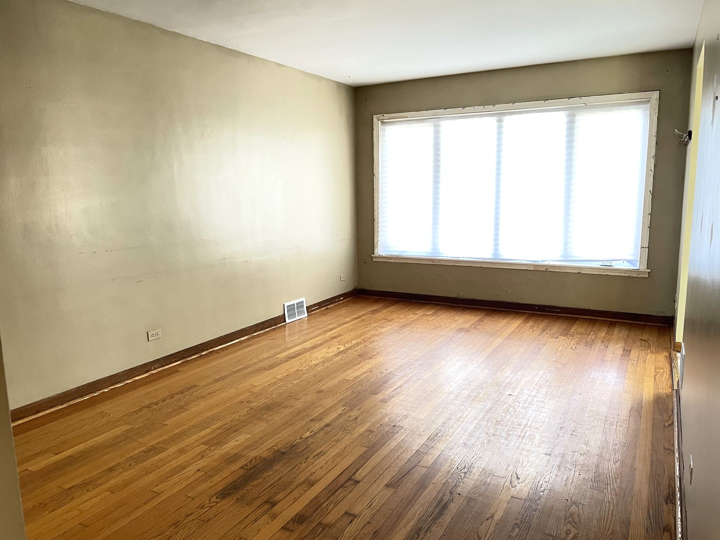 3909 West 71st Street Chicago, IL 60629 - Photo 3 of 16 an empty room with wooden floor and windows