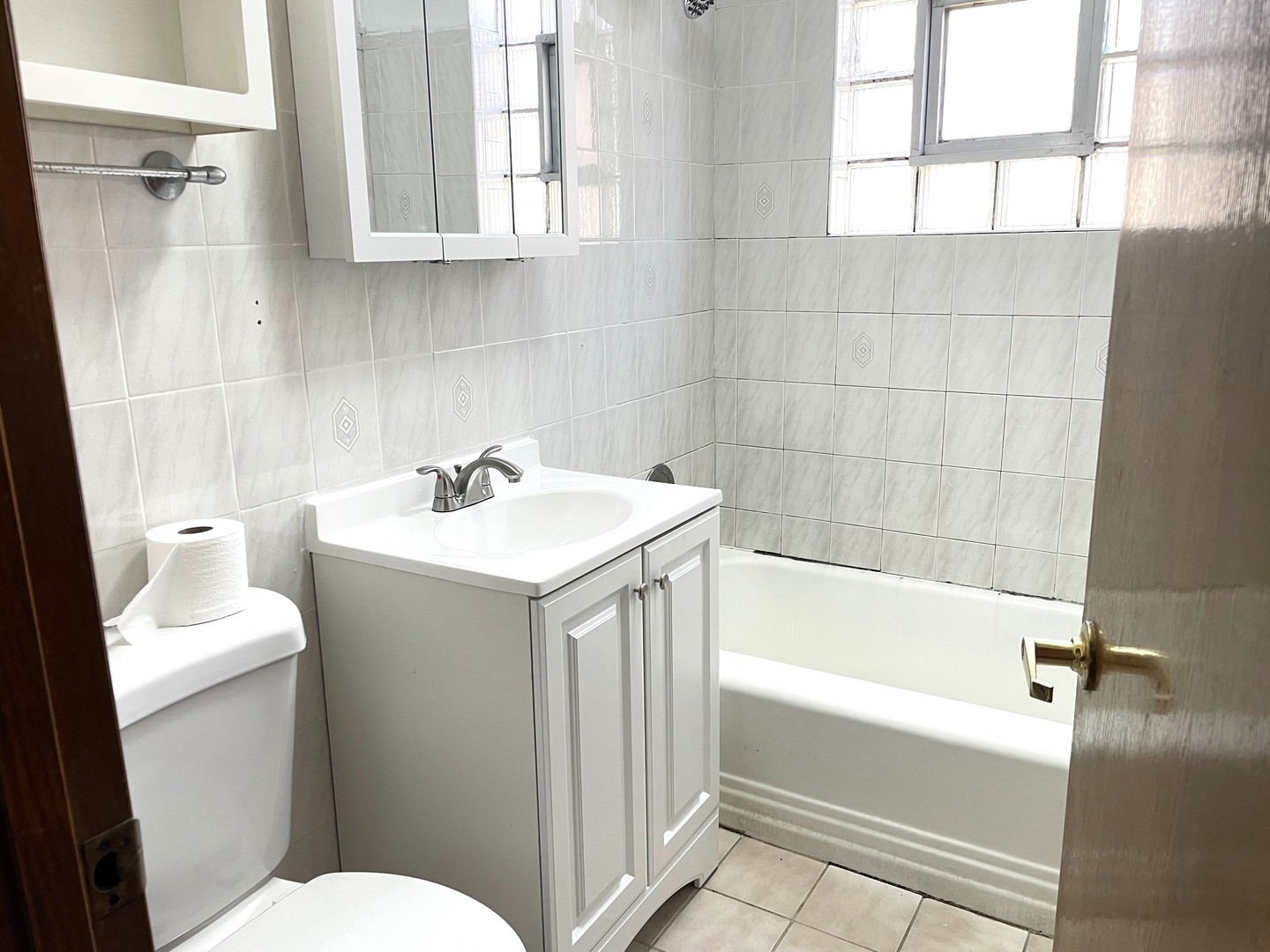 3909 West 71st Street Chicago, IL 60629 - Photo 6 of 16 a bathroom with a sink a toilet and a bathtub