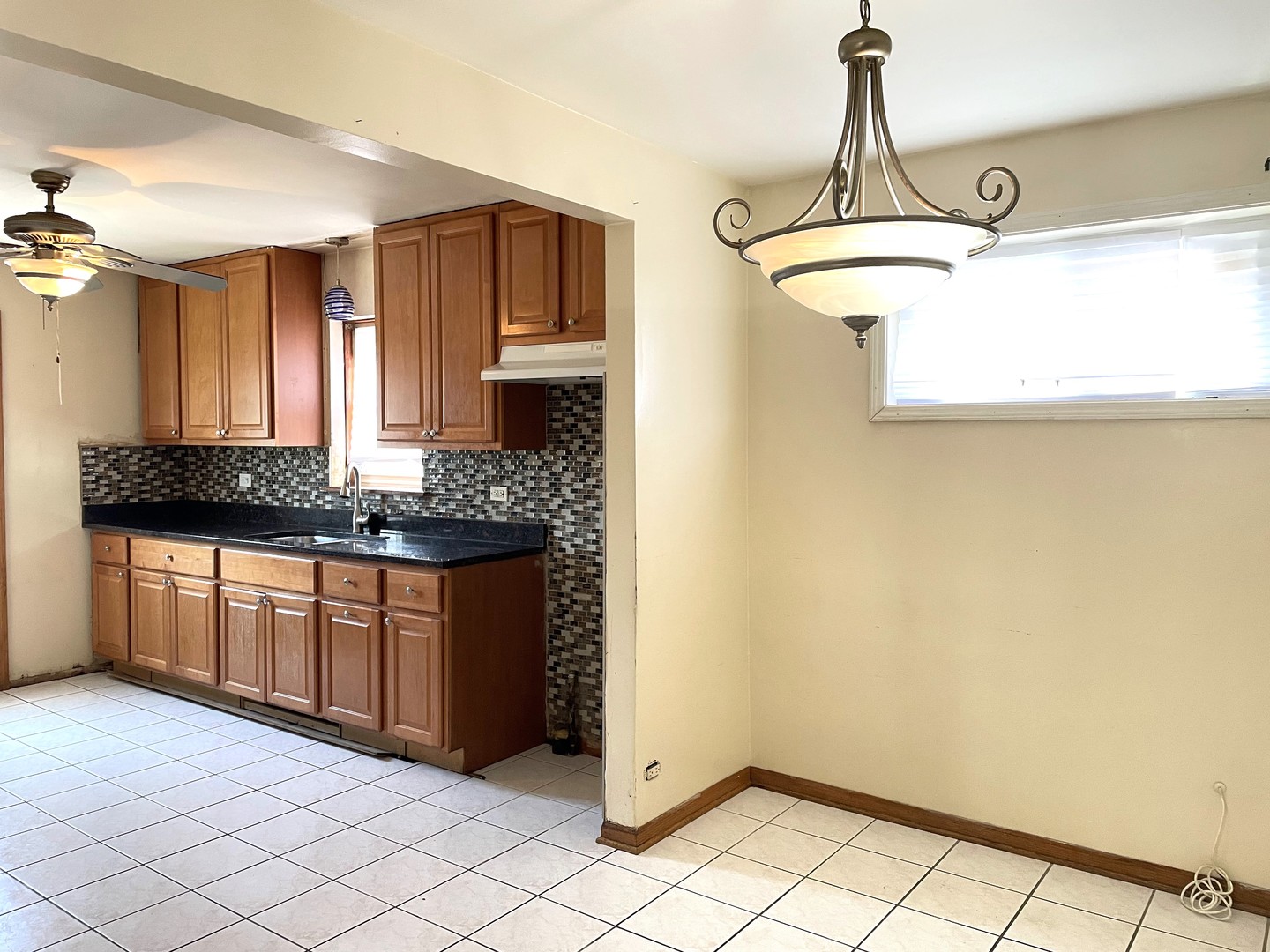 3909 West 71st Street Chicago, IL 60629 - Photo 7 of 16 a kitchen with stainless steel appliances granite countertop a sink and cabinets