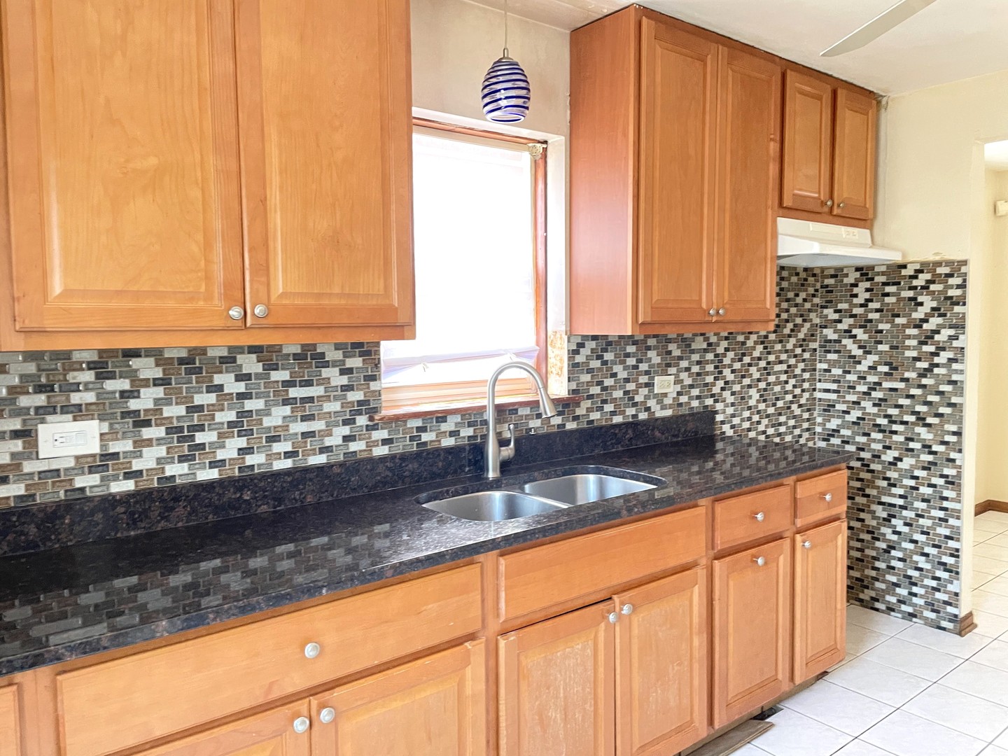 3909 West 71st Street Chicago, IL 60629 - Photo 10 of 16 a kitchen with granite countertop a sink a stove and a granite counter tops