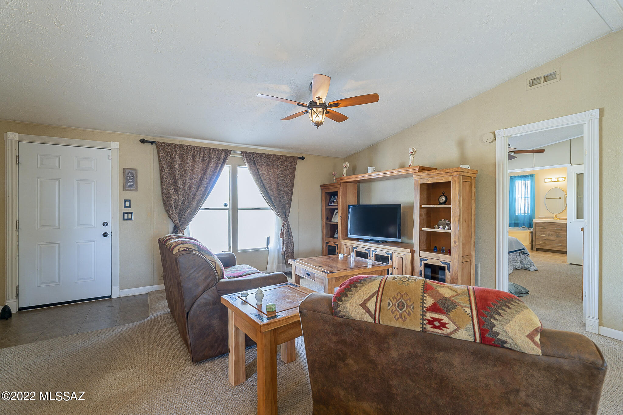 5285 North Puma Road Marana, AZ 85653 - Photo 5 of 46 a living room with furniture and a flat screen tv