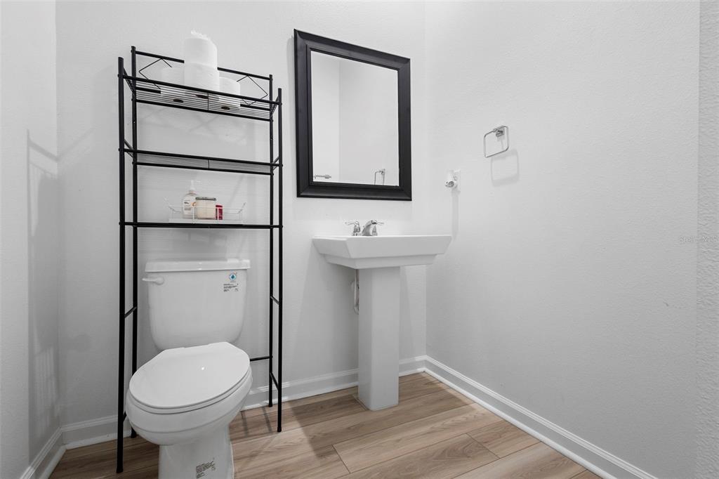 866 Spring Palms Loop Orlando, FL 32828 - Photo 12 of 26 a bathroom with a toilet sink and mirror