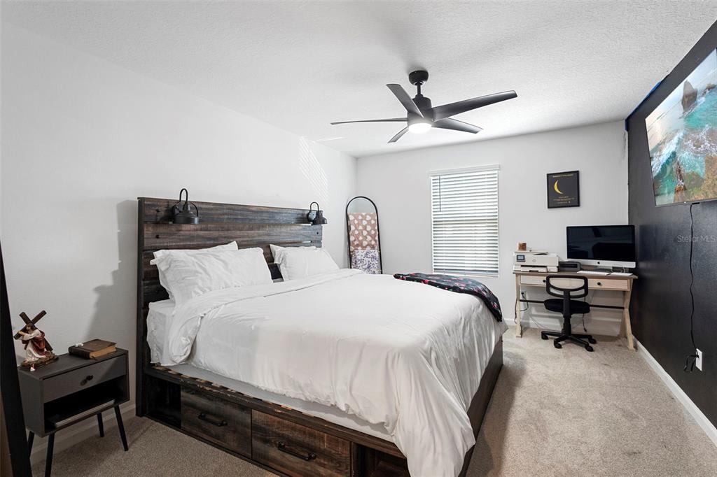 866 Spring Palms Loop Orlando, FL 32828 - Photo 13 of 26 a bedroom with a bed and a flat screen tv