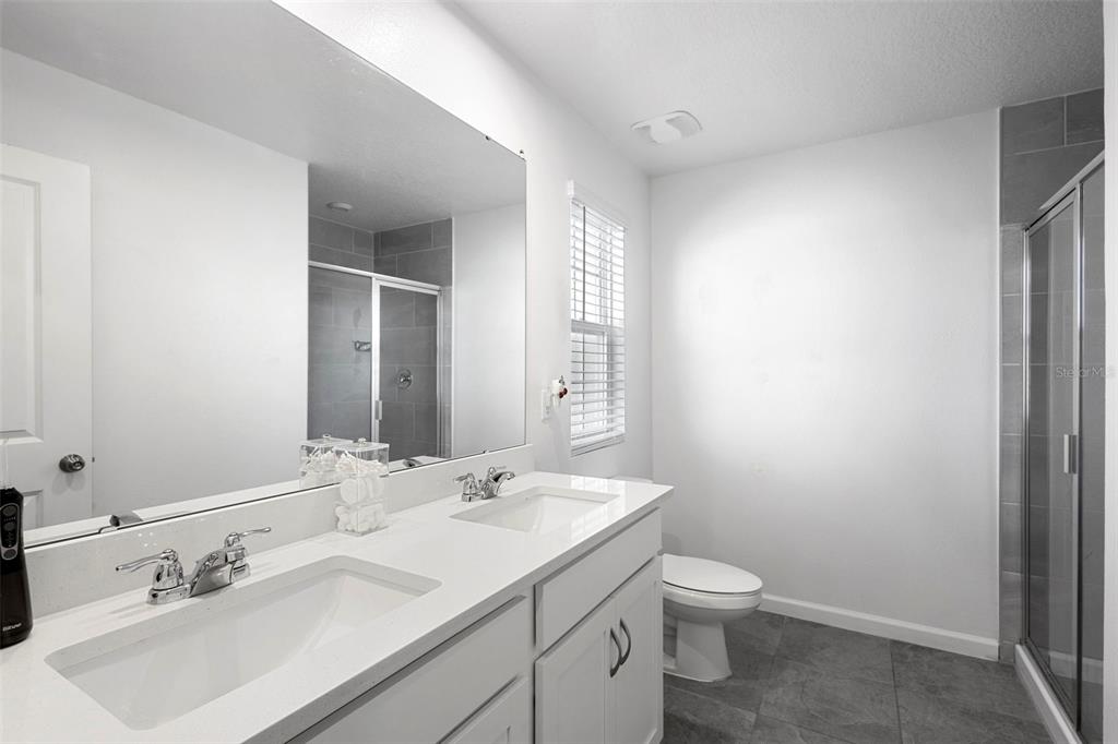 866 Spring Palms Loop Orlando, FL 32828 - Photo 15 of 26 a bathroom with a toilet sink and mirror
