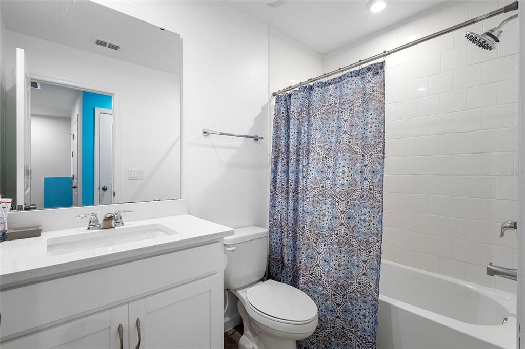 866 Spring Palms Loop Orlando, FL 32828 - Photo 17 of 26 a bathroom with a sink a toilet and shower