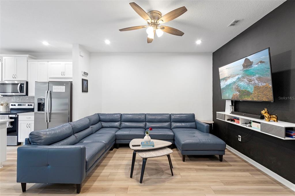 866 Spring Palms Loop Orlando, FL 32828 - Photo 8 of 26 a living room with furniture and a flat screen tv