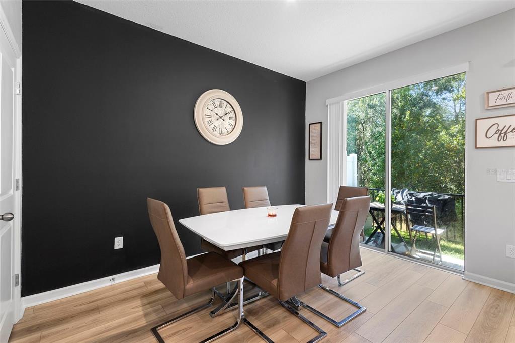 866 Spring Palms Loop Orlando, FL 32828 - Photo 10 of 26 a view of a dining room with furniture window and wooden floor
