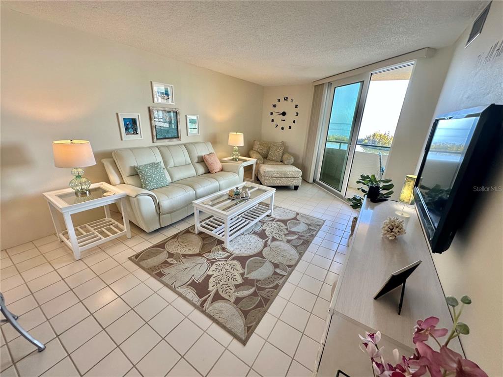 5915 Sea Ranch Drive, Unit 711 Hudson, FL 34667 - Photo 12 of 85 a living room with furniture and a flat screen tv