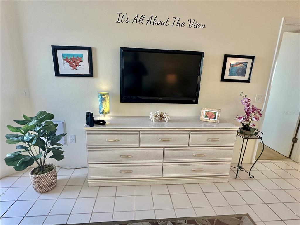 5915 Sea Ranch Drive, Unit 711 Hudson, FL 34667 - Photo 15 of 85 a living room with furniture and a flat screen tv