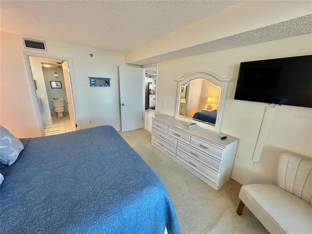 5915 Sea Ranch Drive, Unit 711 Hudson, FL 34667 - Photo 18 of 85 a bedroom with furniture and a flat screen tv