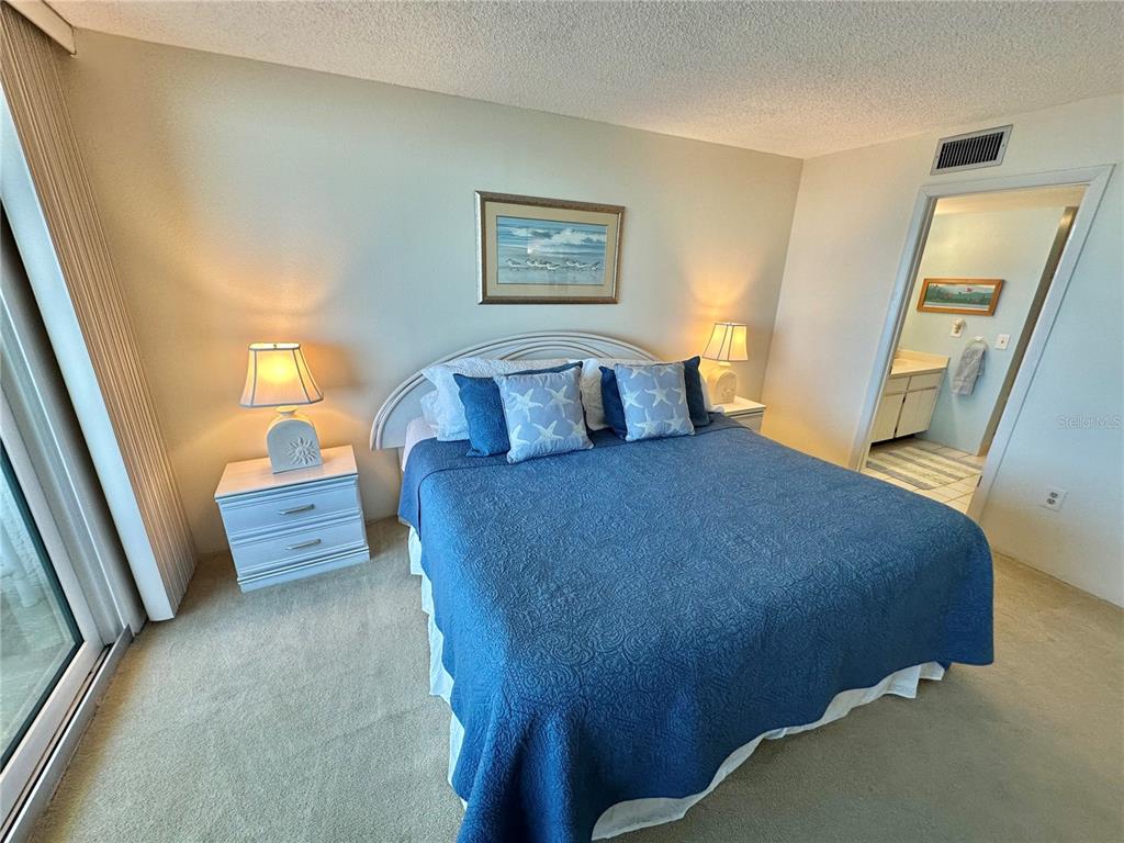 5915 Sea Ranch Drive, Unit 711 Hudson, FL 34667 - Photo 19 of 85 a bedroom with a bed and a walk in closet