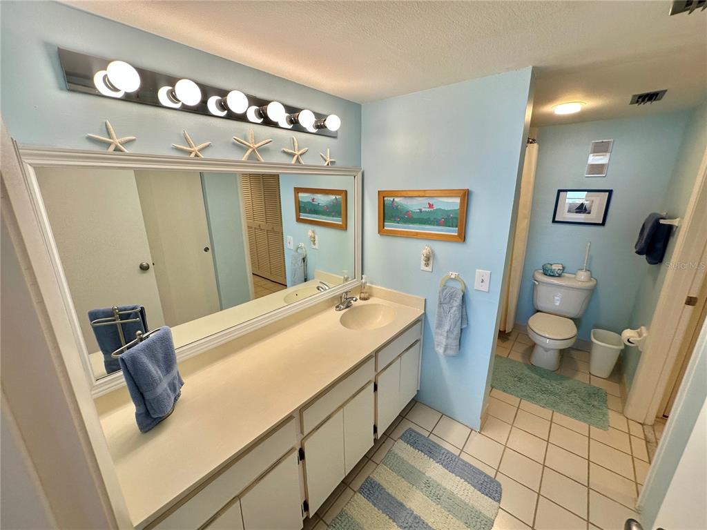 5915 Sea Ranch Drive, Unit 711 Hudson, FL 34667 - Photo 21 of 85 a spacious bathroom with a sink mirror vanity and toilet