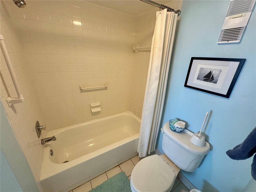 5915 Sea Ranch Drive, Unit 711 Hudson, FL 34667 - Photo 23 of 85 a white toilet sitting next to a bath tub
