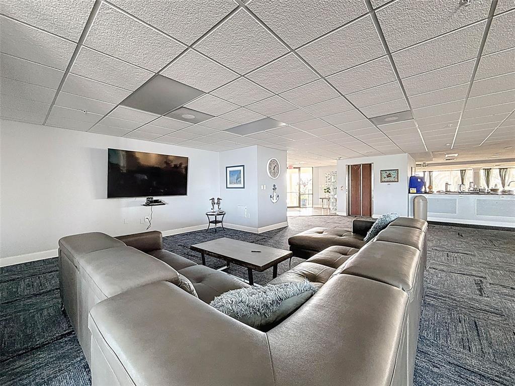 5915 Sea Ranch Drive, Unit 711 Hudson, FL 34667 - Photo 48 of 85 a living room with furniture and a flat screen tv