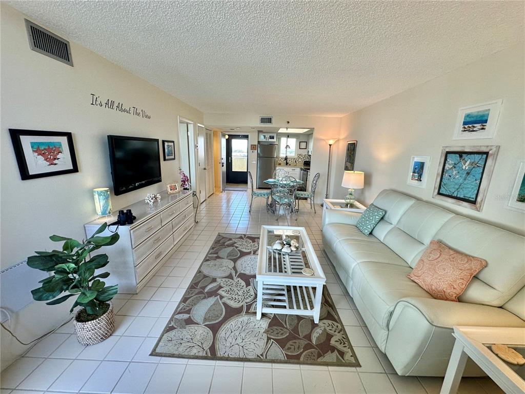 5915 Sea Ranch Drive, Unit 711 Hudson, FL 34667 - Photo 5 of 85 a living room with furniture and a flat screen tv