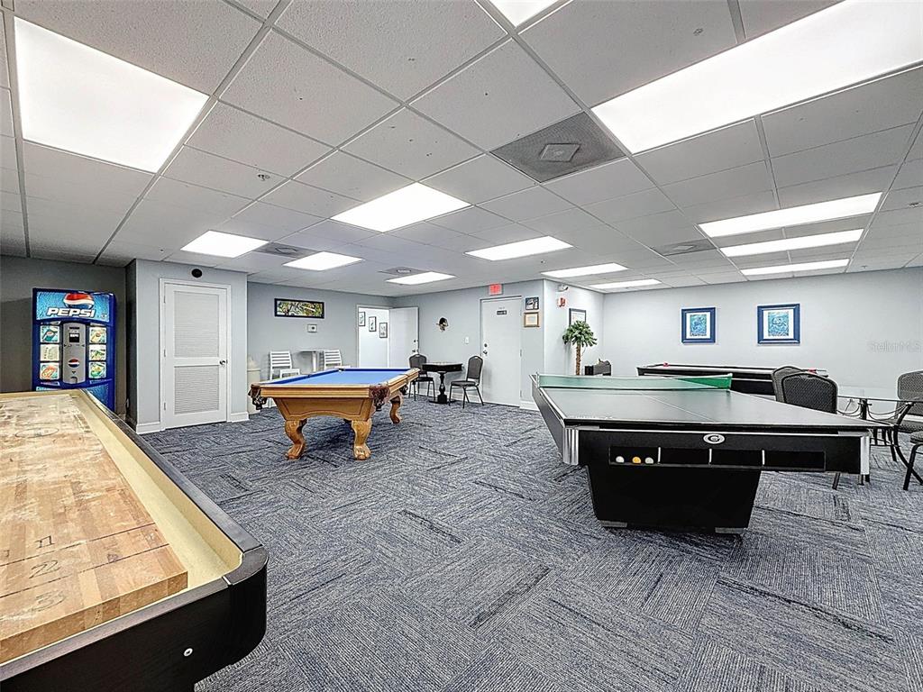 5915 Sea Ranch Drive, Unit 711 Hudson, FL 34667 - Photo 60 of 85 a living room with furniture pool table and a couch