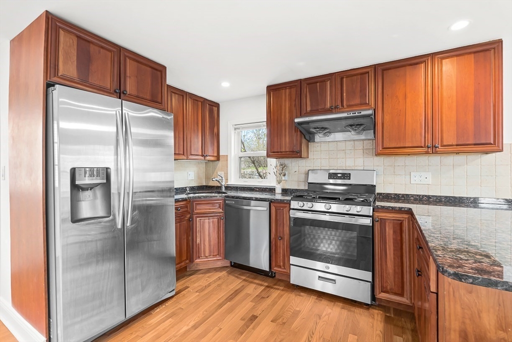 104 Wendell Street Winchester, MA 01890 - Photo 16 of 42 a kitchen with stainless steel appliances granite countertop a refrigerator stove and sink