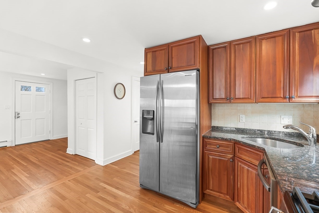 104 Wendell Street Winchester, MA 01890 - Photo 17 of 42 a kitchen with stainless steel appliances granite countertop a refrigerator and a sink