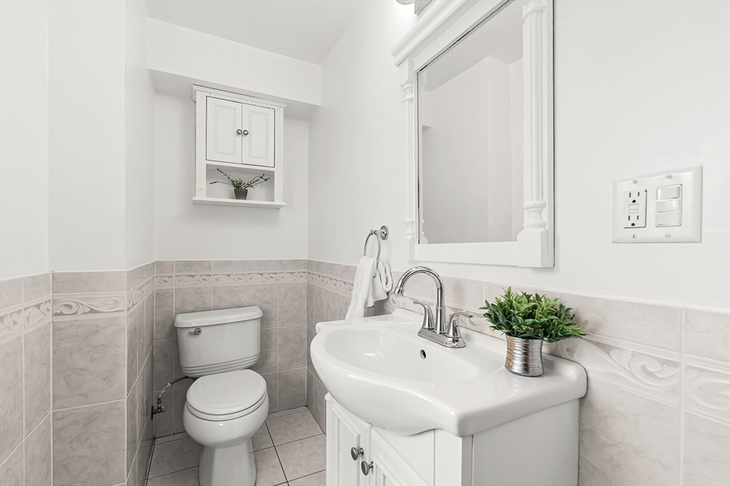 104 Wendell Street Winchester, MA 01890 - Photo 19 of 42 a bathroom with a toilet sink and mirror