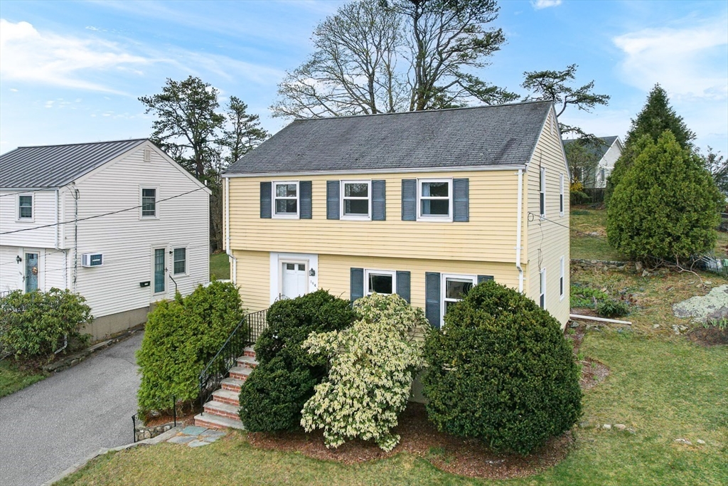 104 Wendell Street Winchester, MA 01890 - Photo 2 of 42 a front view of a house with a garden