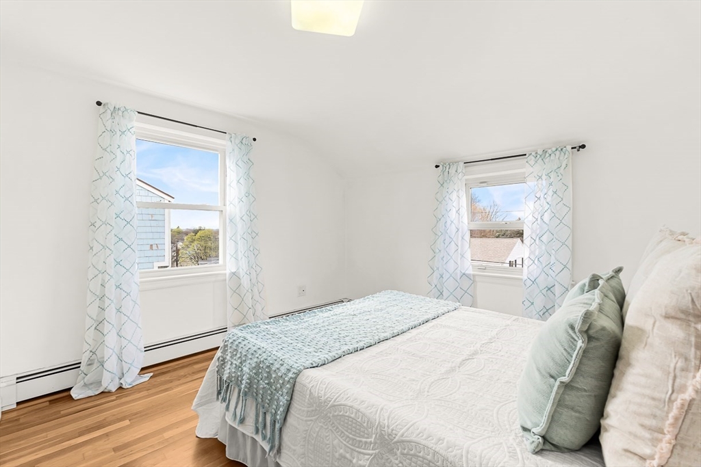 104 Wendell Street Winchester, MA 01890 - Photo 21 of 42 a bedroom with a bed and a mirror