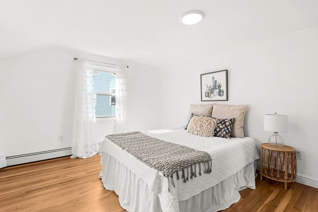 104 Wendell Street Winchester, MA 01890 - Photo 25 of 42 a bedroom with a bed and wooden floor