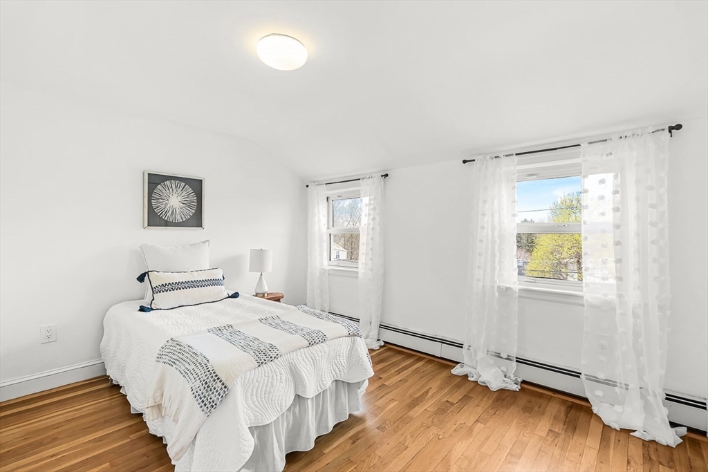 104 Wendell Street Winchester, MA 01890 - Photo 28 of 42 a bedroom with a bed and wooden floor