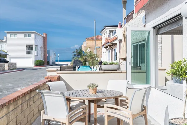 a view of a patio with couches table and chairs and potted plants