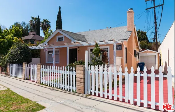 a front view of a house with iron fence