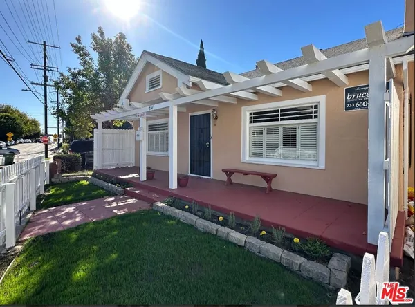 a view of house with outdoor seating and yard