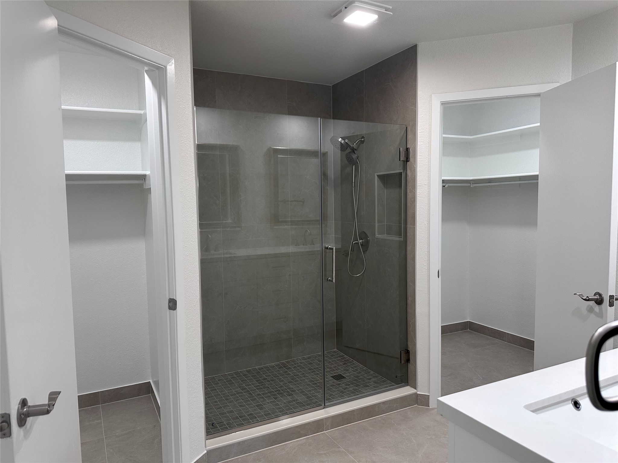 12610 Andromeda Cove Austin, TX 78727 - Photo 14 of 29 Clean lines define this modern bathroom featuring a tiled walk-in shower and nearby walk-in closet.