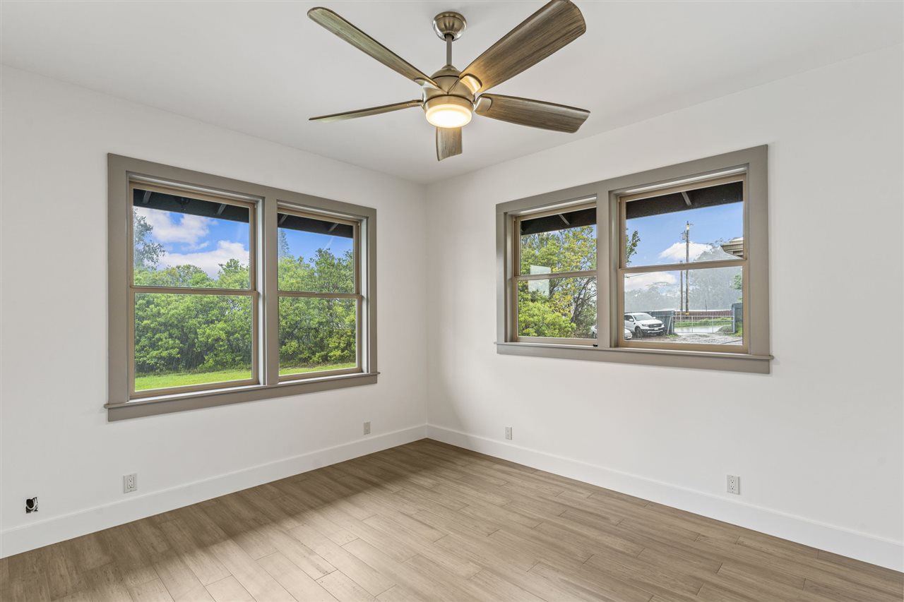 780 West Kuiaha Road Haiku, HI 96708 - Photo 23 of 30 a view of an empty room with wooden floor and a window