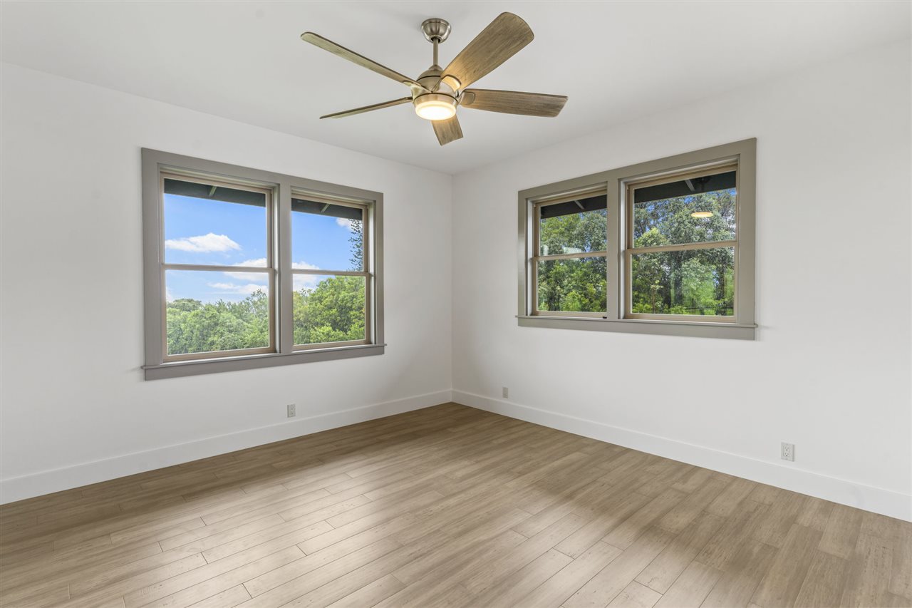 780 West Kuiaha Road Haiku, HI 96708 - Photo 27 of 30 a view of an empty room with wooden floor and a window