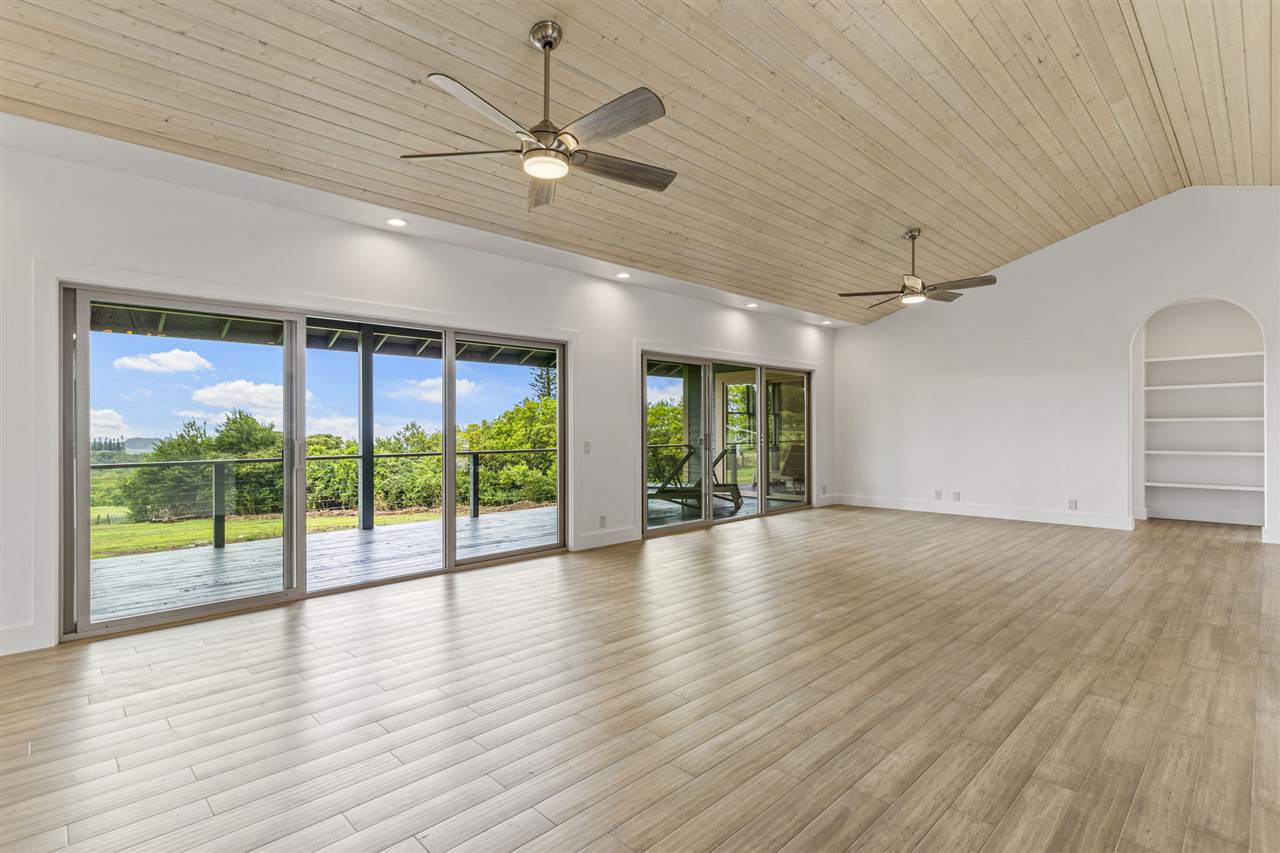 780 West Kuiaha Road Haiku, HI 96708 - Photo 4 of 30 a view of an empty room with wooden floor and a window