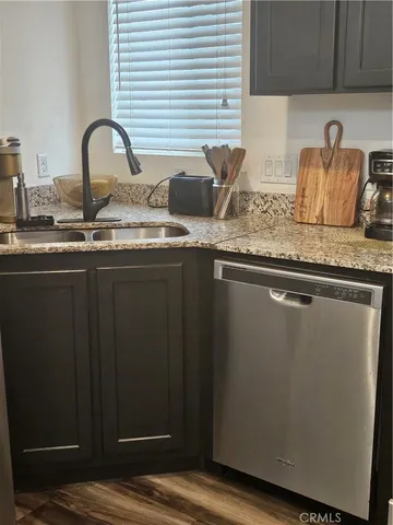 a kitchen with granite countertop a sink and cabinets