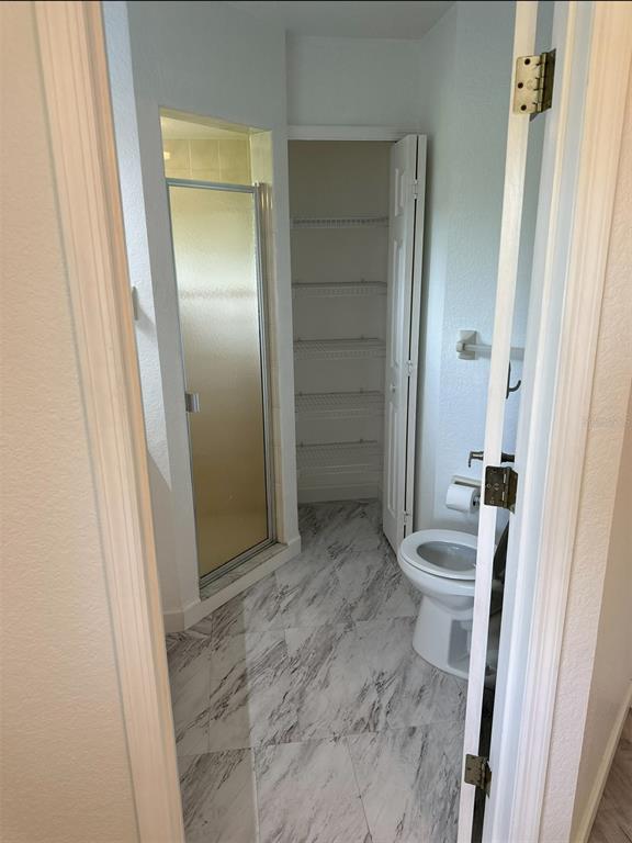 6967 Crown Drive, Unit B Englewood, FL 34224 - Photo 11 of 16 a bathroom with a granite countertop sink a toilet and shower