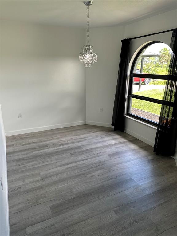 6967 Crown Drive, Unit B Englewood, FL 34224 - Photo 2 of 16 a view of empty room with wooden floor and fan