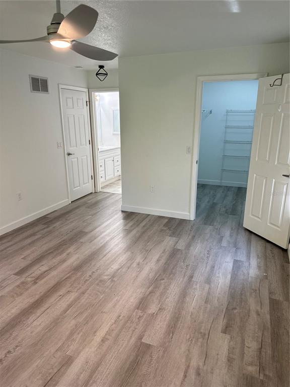 6967 Crown Drive, Unit B Englewood, FL 34224 - Photo 5 of 16 wooden floor in an empty room with a window