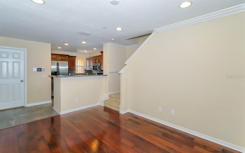 7339 Black Walnut Way Lakewood Ranch, FL 34202 - Photo 6 of 27 a view of a kitchen with wooden floor and a window