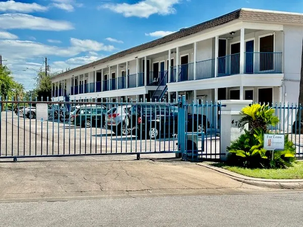 a front view of a building with a garden